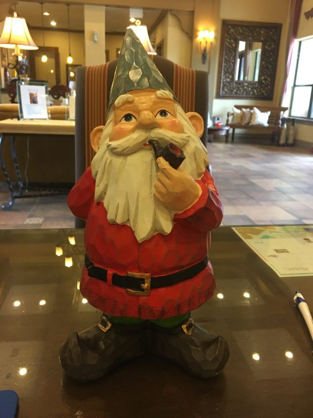 A statue of a gnome sitting on a table in San Antonio.