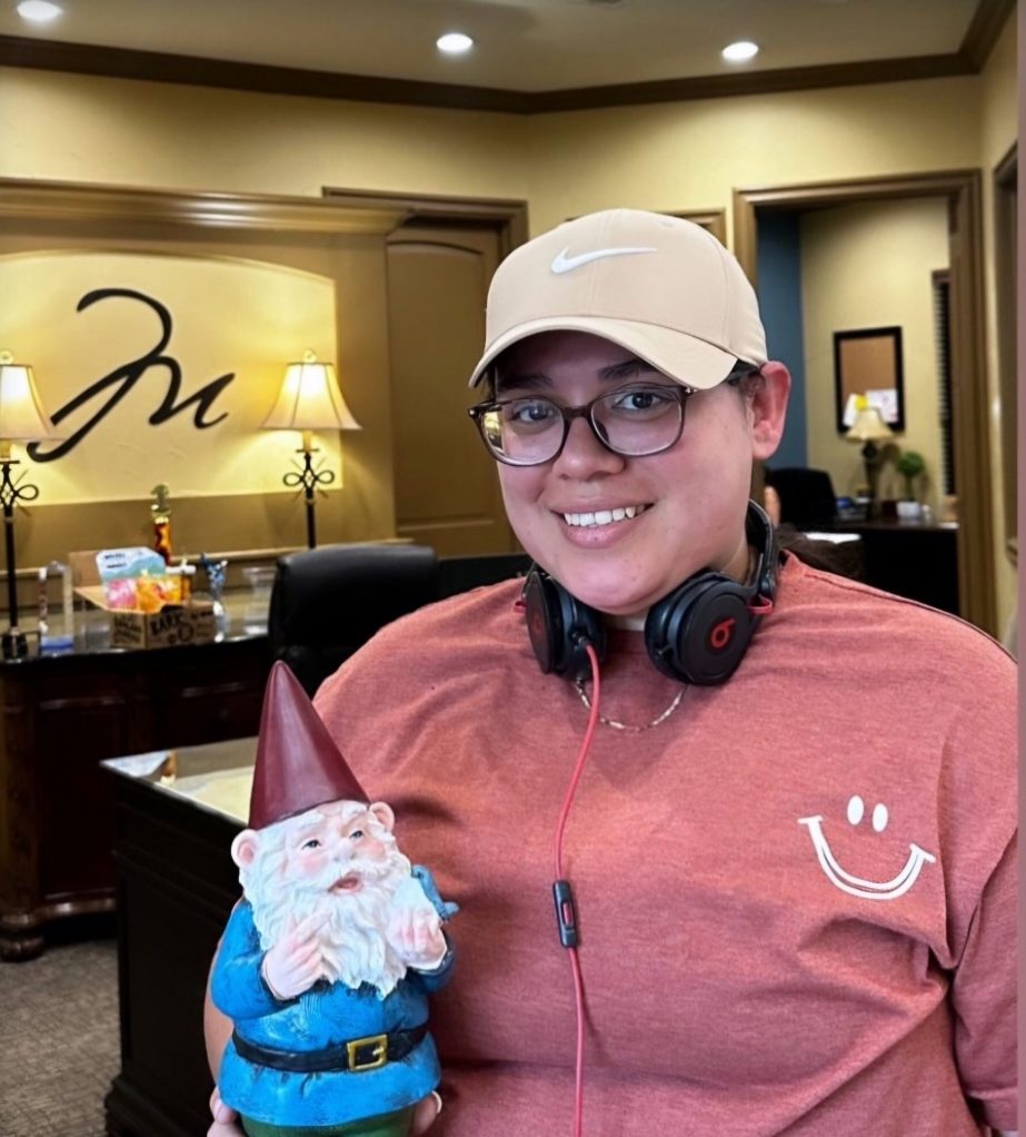 San Antonio Apartments on the North Loop Person in a cap and headphones holding a garden gnome, standing in a warmly lit office with wooden furniture, reminiscent of a cozy Texas apartment. The Montecristo Apartments in San Antonio 215 North Loop 1604 E San Antonio, TX 78232 p: (210) 672-4919 f: (210) 877-5455